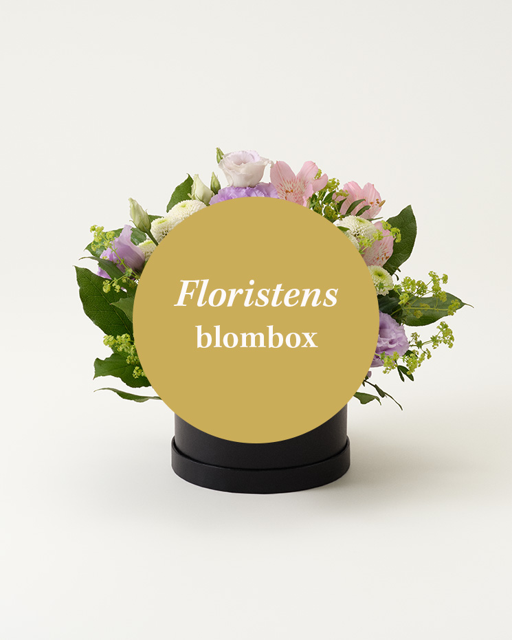 Låt floristen skapa en vacker blombox! Floristens val - blombox. Den lokala floristen arrangerar en fin blomsterdekoration i en rund blombox. ´Blomstersorter kan variera under olika säsonger och i olika blomsterbutiker.